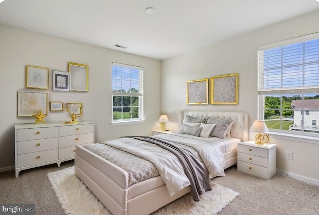 bedroom featuring baseboards, visible vents, and carpet flooring