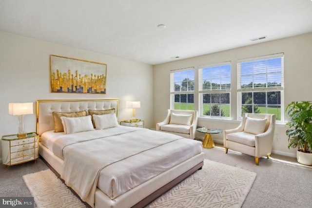 carpeted bedroom with visible vents and baseboards