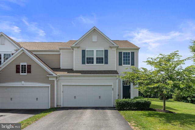 view of front of house with aphalt driveway and a front yard