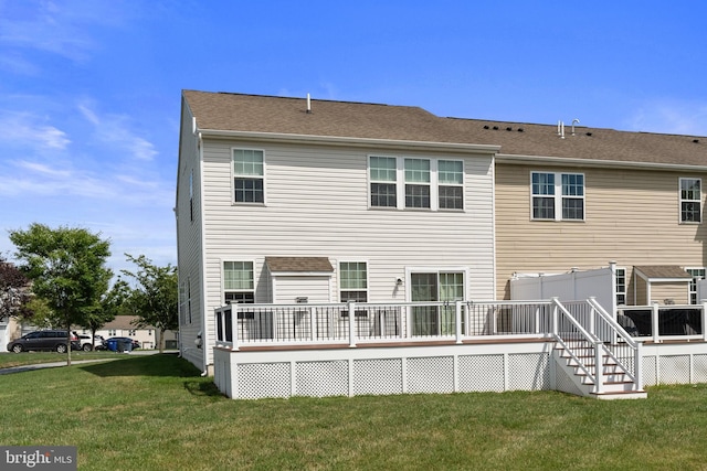 rear view of house featuring a yard and a wooden deck