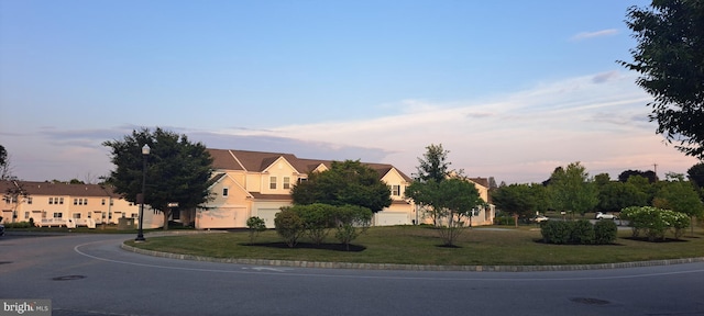 view of street featuring street lights and curbs