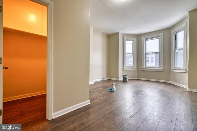 unfurnished room featuring dark hardwood / wood-style flooring