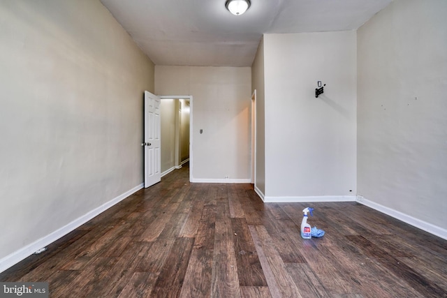 empty room with dark wood-type flooring