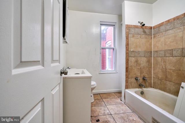 full bathroom featuring tile patterned floors, vanity, tiled shower / bath combo, and toilet