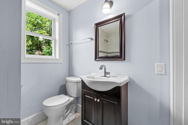 bathroom with tile patterned flooring, vanity, toilet, and baseboard heating