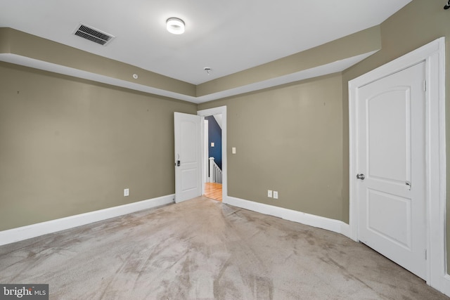 unfurnished bedroom featuring light carpet