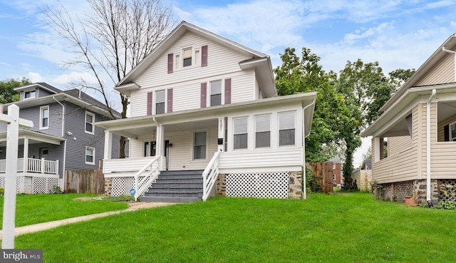 front of property featuring covered porch and a front yard