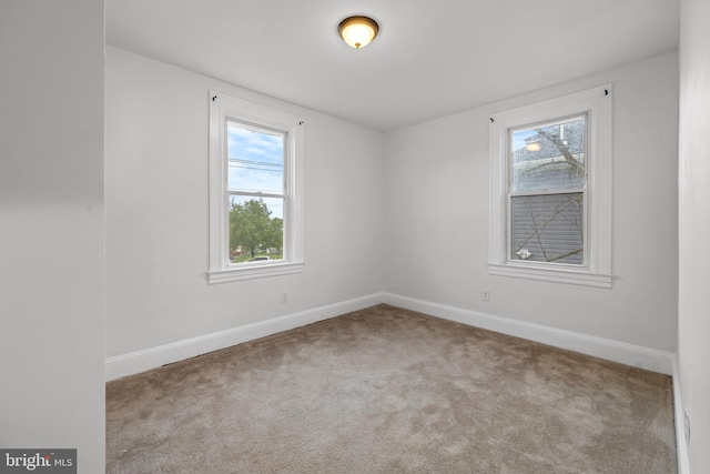 spare room with light carpet and a healthy amount of sunlight