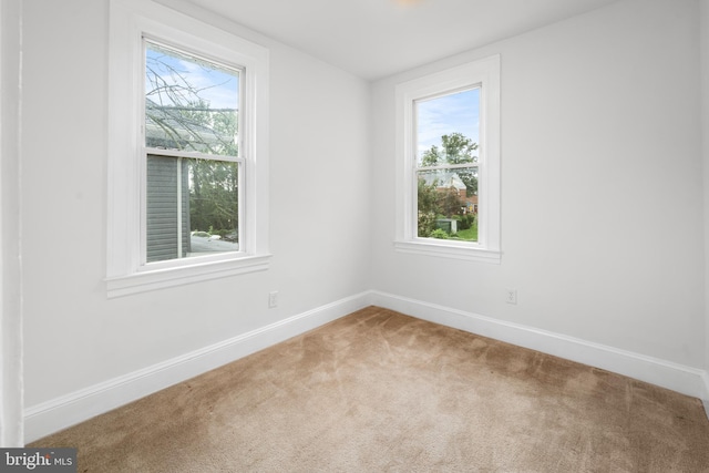 carpeted empty room with a healthy amount of sunlight