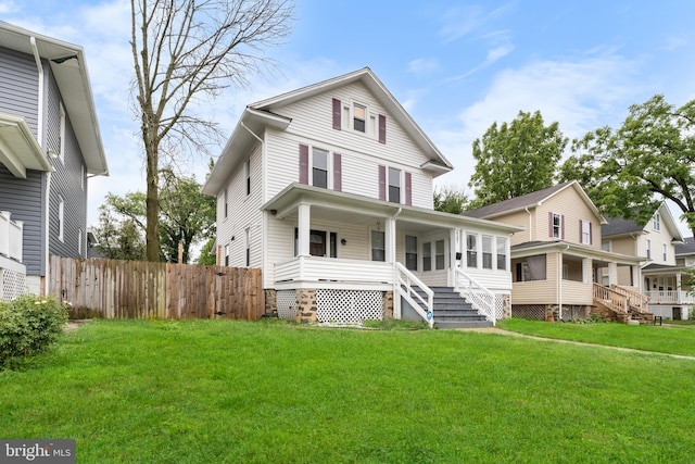 view of front facade with covered porch and a front lawn