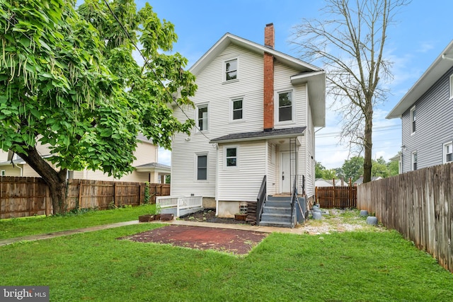 back of property featuring a lawn and a patio area