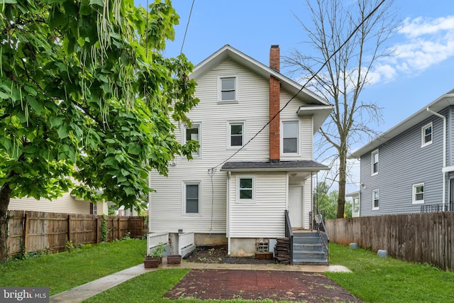 back of house with a yard