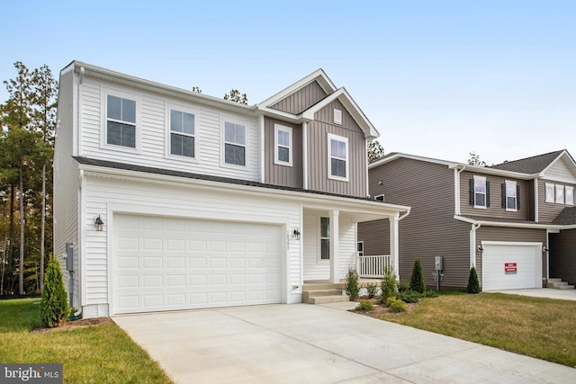 view of front of house featuring a porch, a garage, and a front lawn