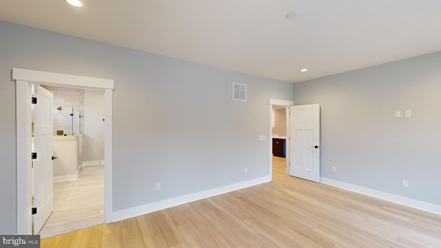 empty room with light hardwood / wood-style flooring