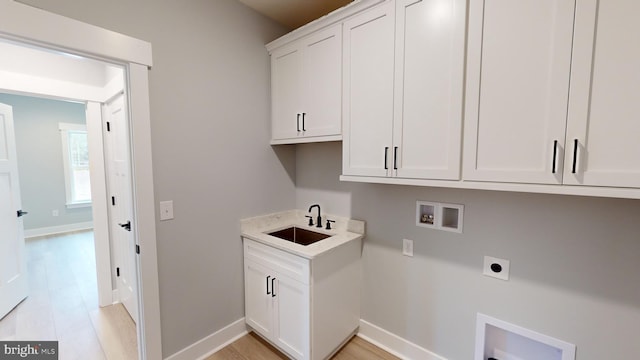 laundry area with sink, cabinets, hookup for an electric dryer, hookup for a washing machine, and light hardwood / wood-style floors