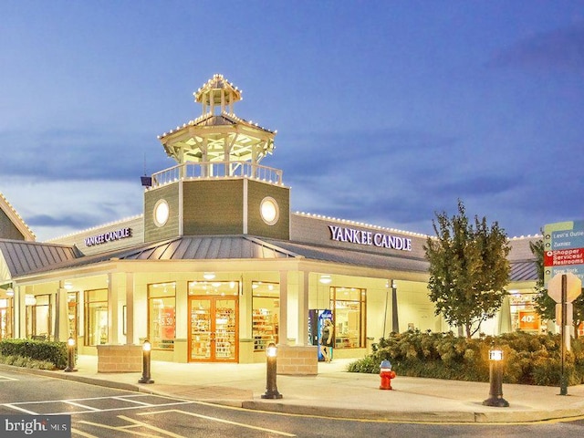 view of outdoor building at dusk