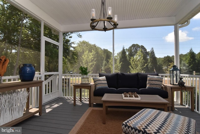 sunroom / solarium with an inviting chandelier