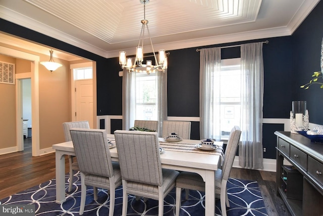 dining room featuring ornamental molding, dark wood-type flooring, and a chandelier