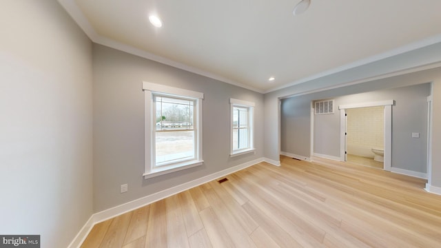 unfurnished room with light hardwood / wood-style flooring and ornamental molding