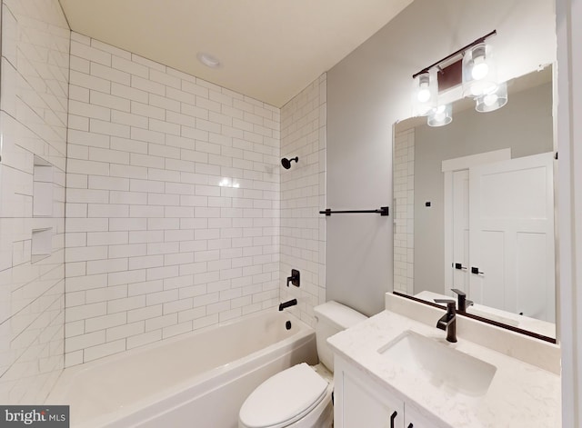 full bathroom featuring toilet, vanity, and tiled shower / bath