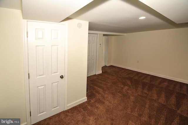 basement featuring dark colored carpet