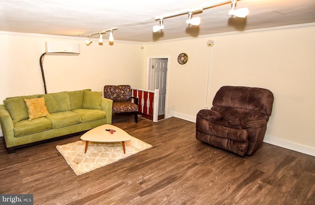 living room featuring a wall mounted air conditioner, rail lighting, crown molding, and dark wood-type flooring