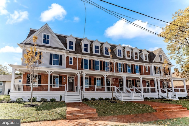 view of front of house with covered porch and a front yard