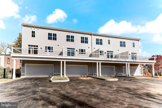 rear view of property with a garage