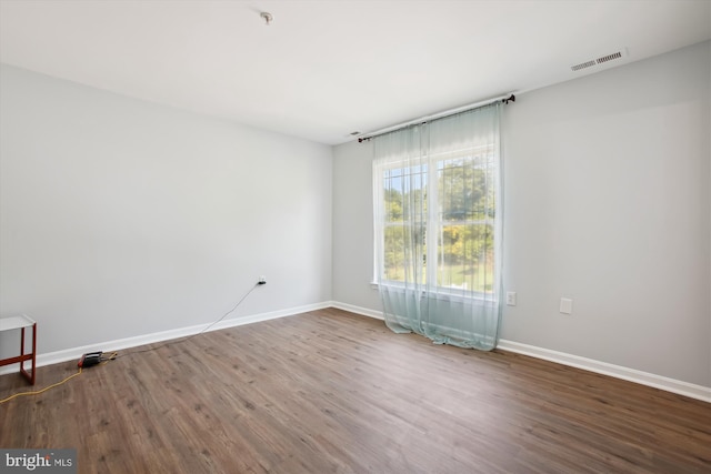 spare room with hardwood / wood-style floors