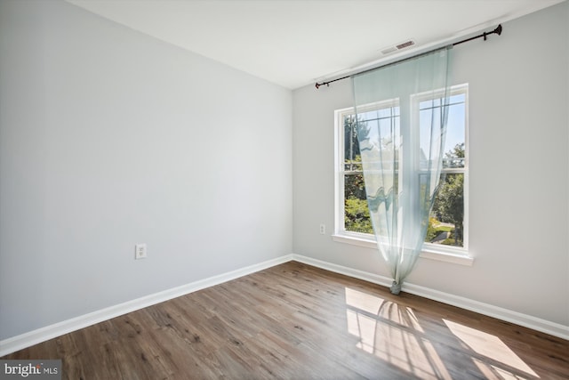 unfurnished room featuring hardwood / wood-style flooring