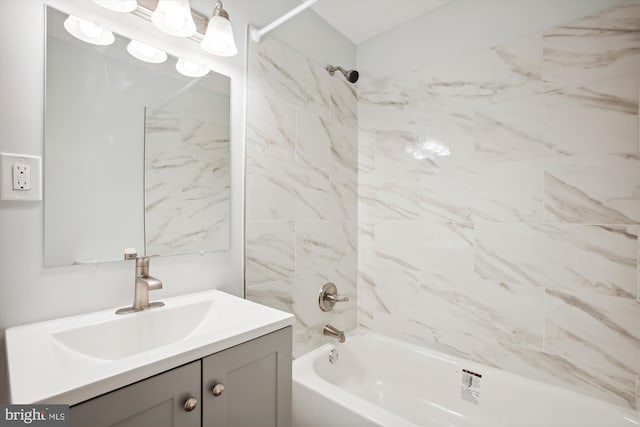 bathroom with vanity and tiled shower / bath combo