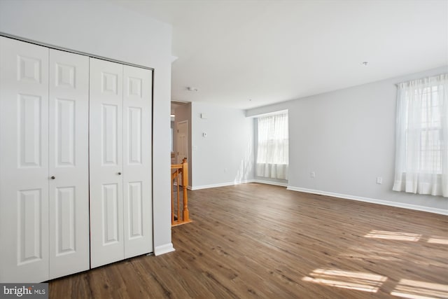 unfurnished bedroom featuring a closet and hardwood / wood-style floors