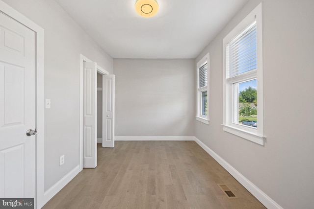 hallway with light hardwood / wood-style floors