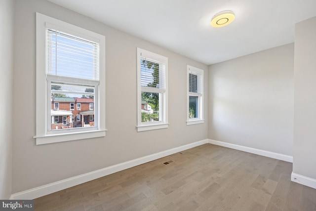 empty room with light hardwood / wood-style floors