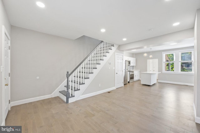 unfurnished living room with light wood-type flooring