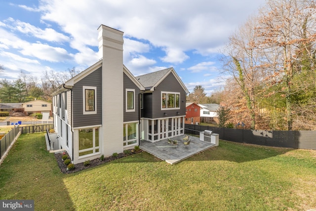 rear view of house with a patio area and a yard