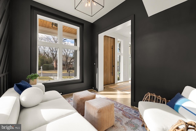 interior space with an inviting chandelier and light hardwood / wood-style flooring