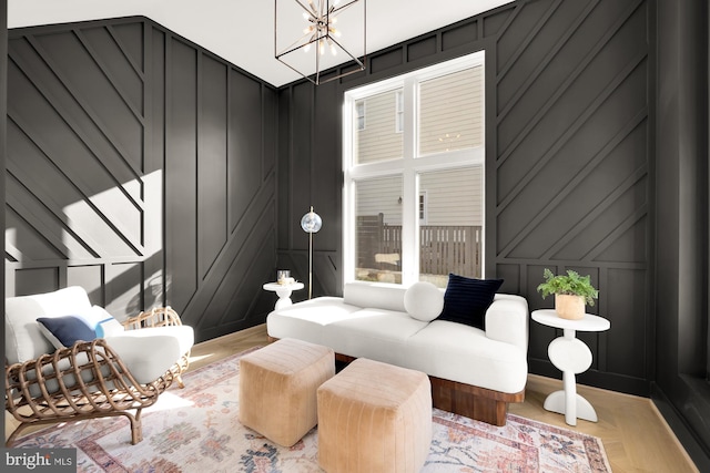 living room with light parquet floors and a chandelier