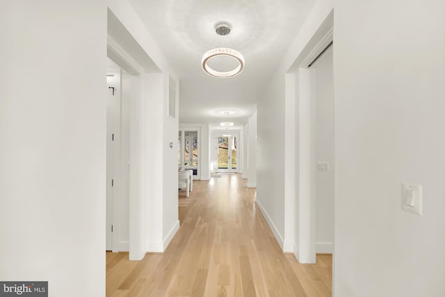 hallway with light hardwood / wood-style floors