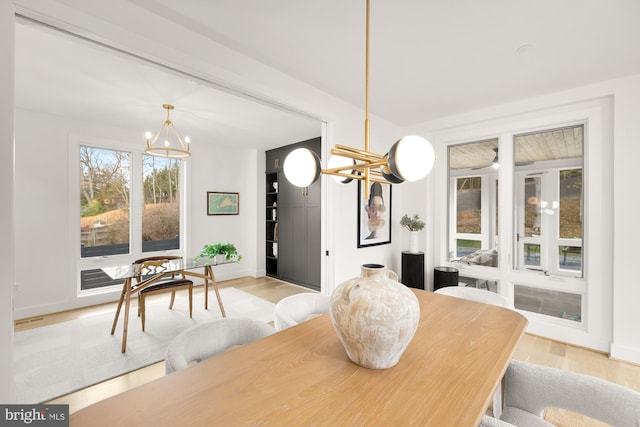 dining room featuring a notable chandelier and light wood-type flooring