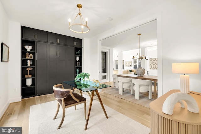 dining space with an inviting chandelier and light wood-type flooring