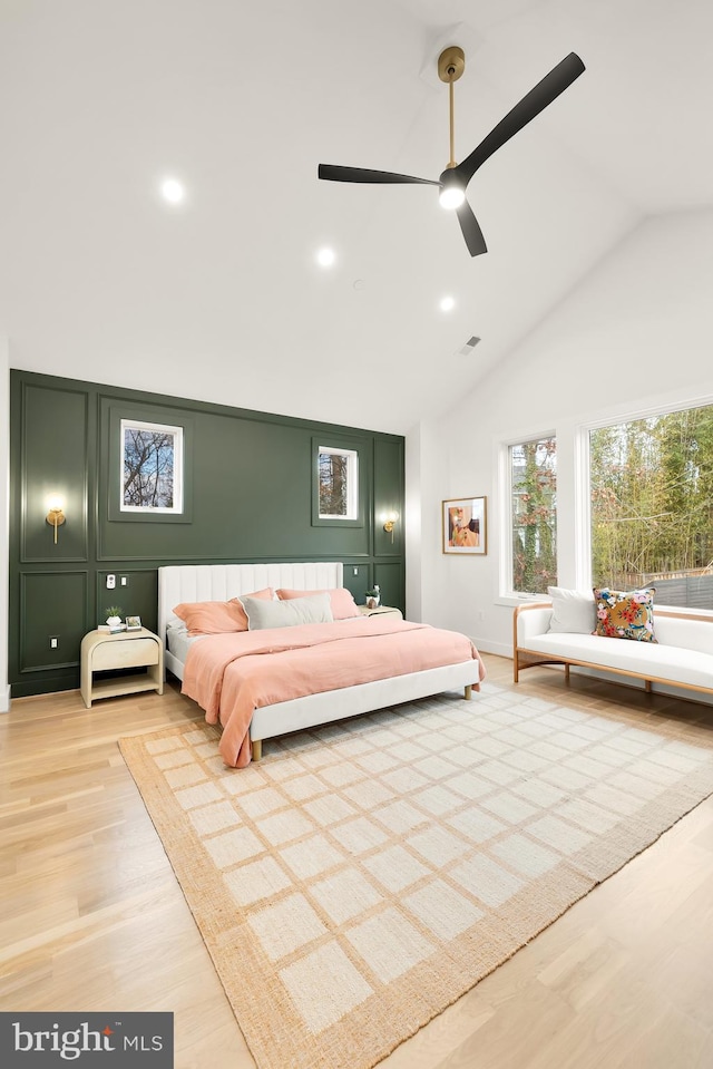 bedroom featuring high vaulted ceiling, ceiling fan, and light hardwood / wood-style flooring