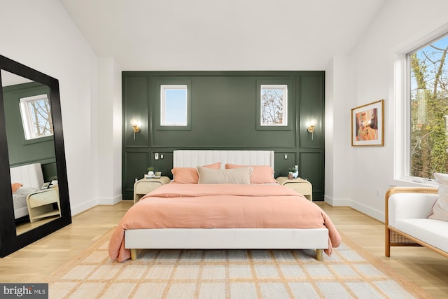 bedroom featuring light hardwood / wood-style flooring and vaulted ceiling