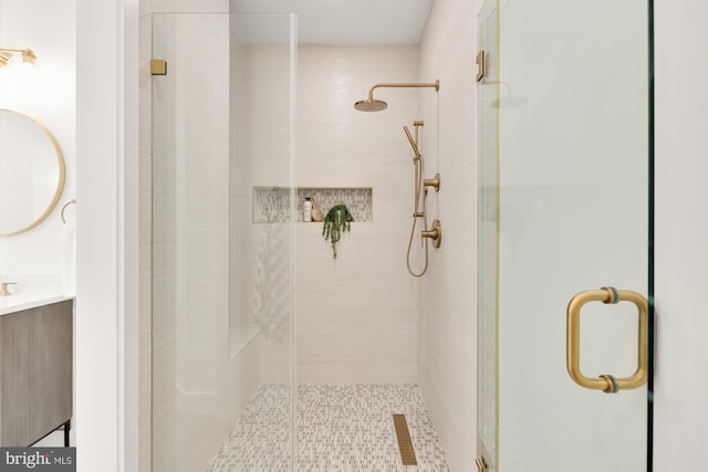 bathroom featuring walk in shower and vanity