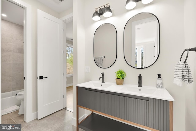 full bathroom featuring toilet, tiled shower / bath, tile patterned floors, and vanity