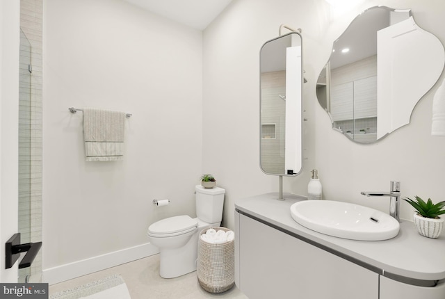 bathroom featuring toilet, vanity, and tile patterned floors