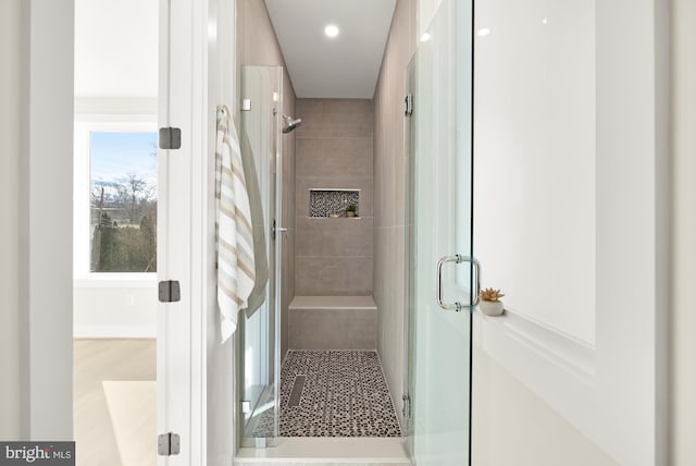 bathroom featuring a shower with door