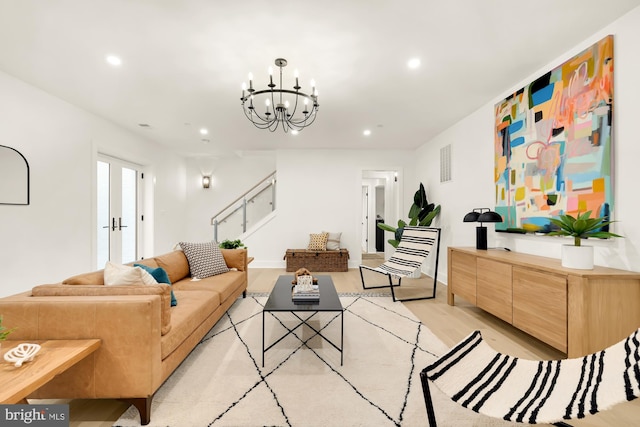 living room featuring an inviting chandelier and light hardwood / wood-style flooring