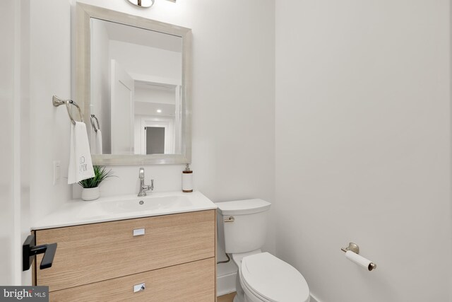 bathroom with toilet and vanity