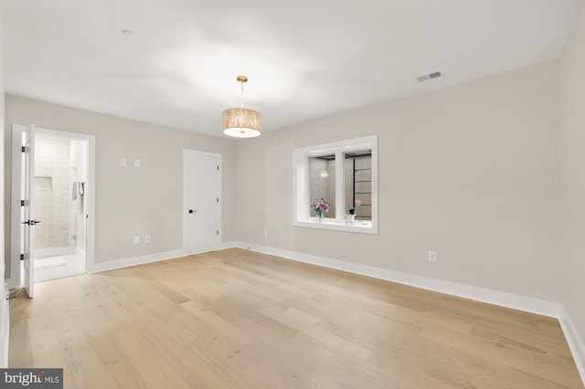 spare room with light wood-type flooring